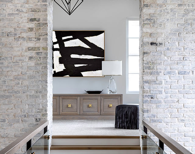 Carrara marble kitchen with luxury range and custom pot holder detail in Houston, TX